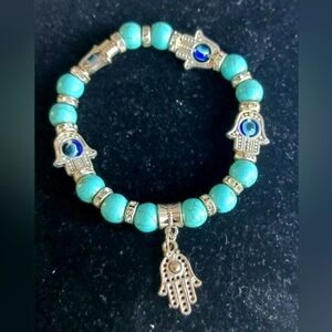 Hamsa hand Silver color stretch bracelet with turquoise stones. NWOT